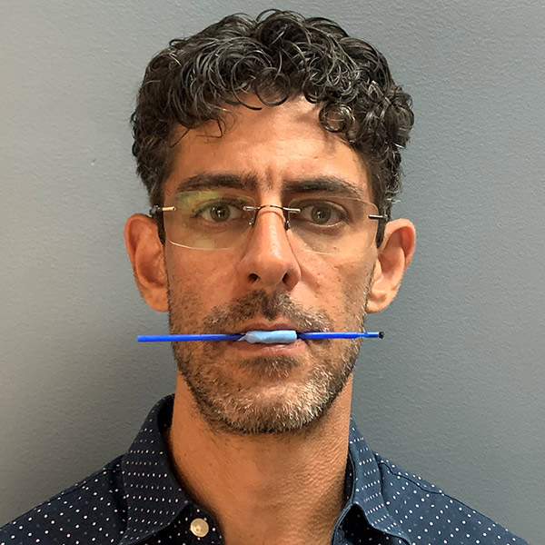 man holding stick in his mouth